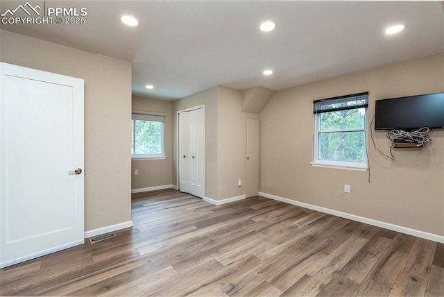 additional living space with light wood-type flooring