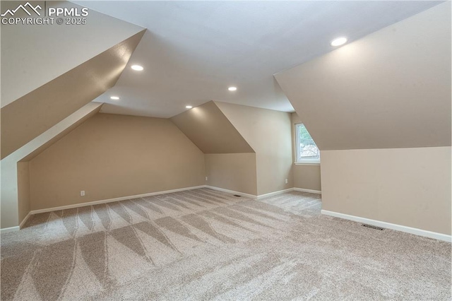 additional living space with lofted ceiling and light carpet