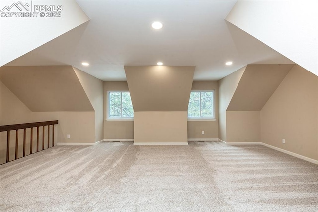 additional living space with lofted ceiling and light colored carpet