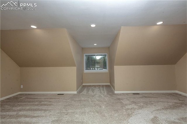 additional living space with light carpet and lofted ceiling