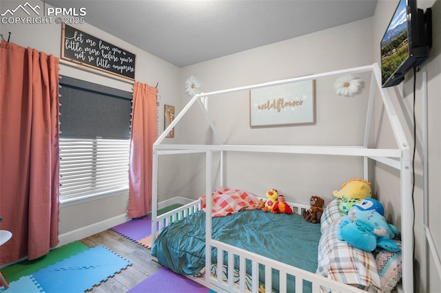 bedroom with wood-type flooring