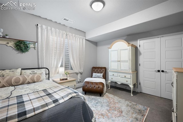 bedroom featuring dark carpet and a closet