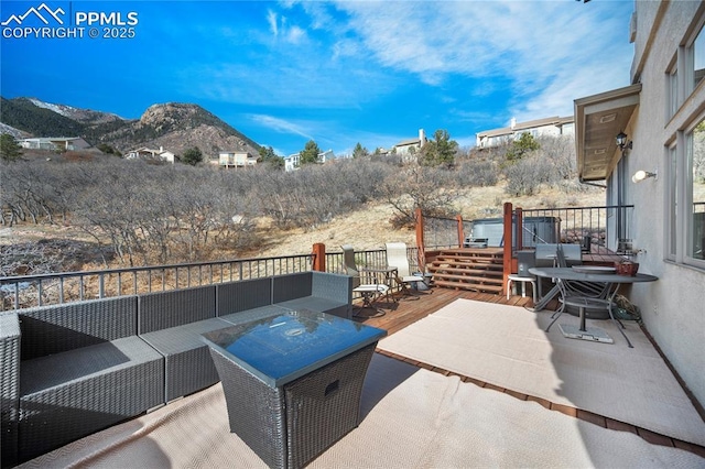 view of patio / terrace with outdoor lounge area and a deck with mountain view