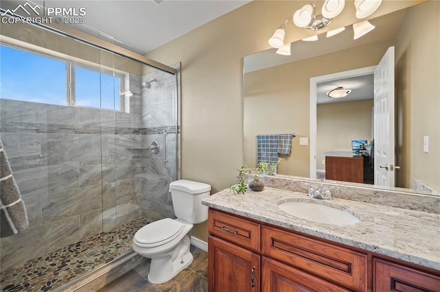 bathroom with vanity, toilet, and walk in shower