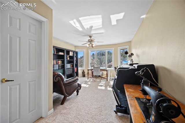 office featuring light carpet and ceiling fan