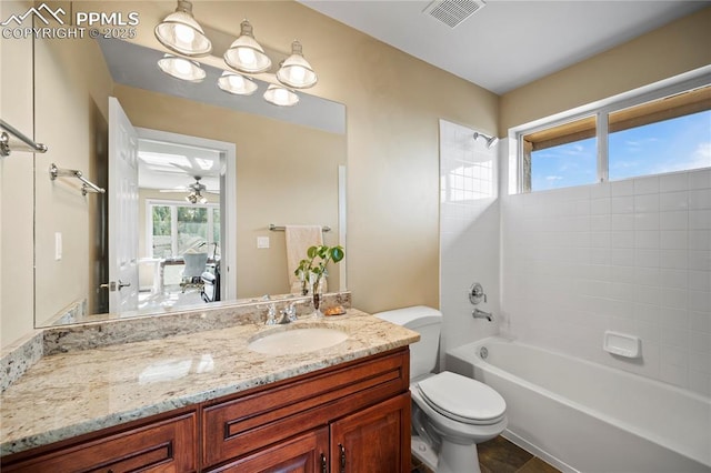 full bathroom with washtub / shower combination, vanity, and toilet