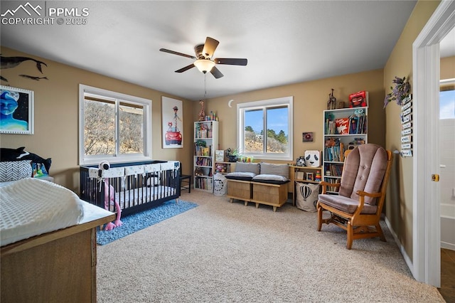 bedroom featuring light colored carpet and ceiling fan