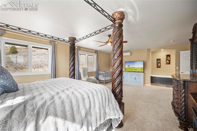 bedroom with a wall unit AC and light colored carpet