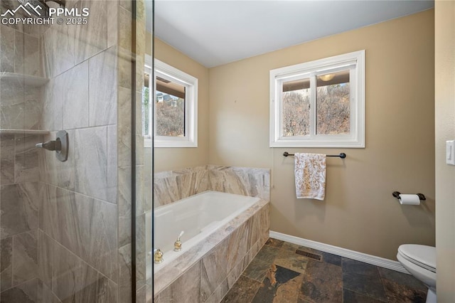 bathroom featuring toilet and separate shower and tub