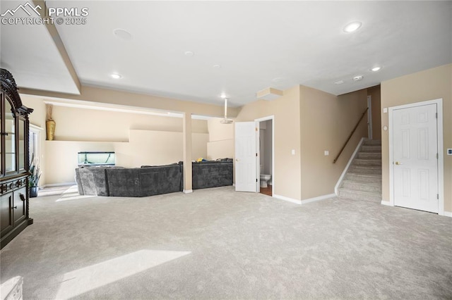 unfurnished living room featuring light colored carpet