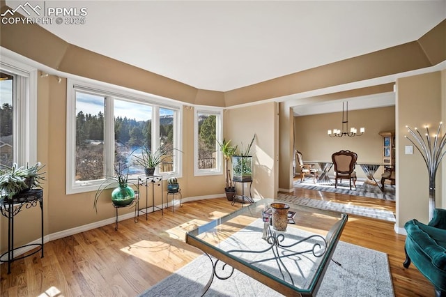 interior space with an inviting chandelier and hardwood / wood-style floors