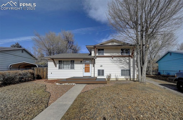 split level home featuring a front yard and a carport