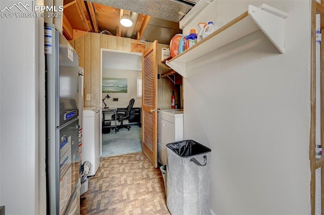 walk in closet featuring washer / clothes dryer and light parquet flooring