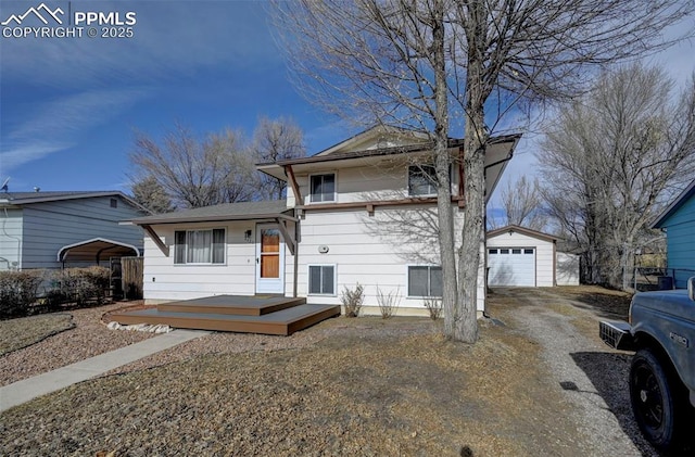 view of front of property featuring a garage, an outdoor structure, and a carport