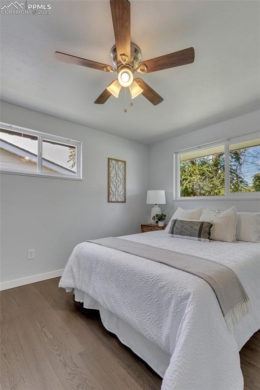 bedroom with ceiling fan and dark hardwood / wood-style floors