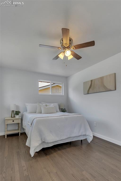 bedroom featuring wood-type flooring and ceiling fan