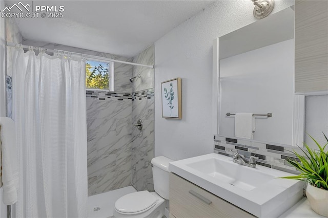 bathroom featuring tasteful backsplash, vanity, a shower with shower curtain, and toilet