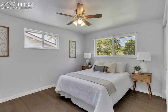 bedroom with multiple windows, dark hardwood / wood-style floors, and ceiling fan