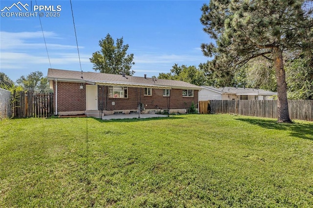 rear view of property with a patio and a lawn