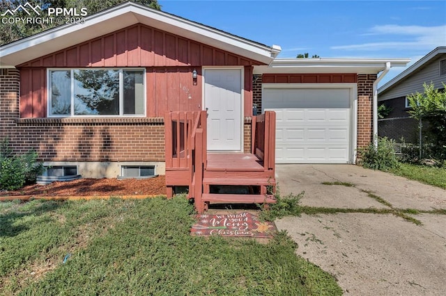 ranch-style house with a garage and a front lawn