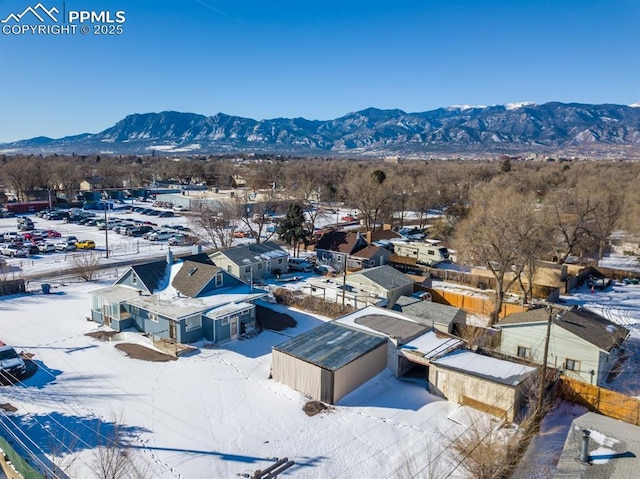 snowy aerial view featuring a mountain view