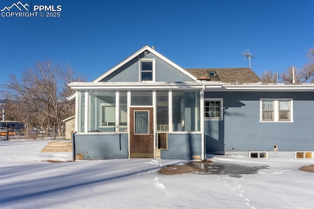 view of front of house with a sunroom