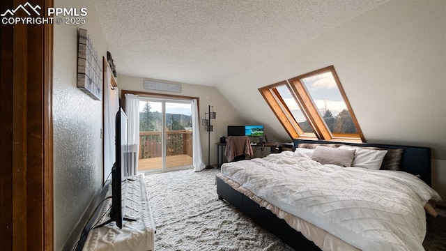 bedroom featuring access to exterior, carpet floors, lofted ceiling with skylight, and a textured ceiling