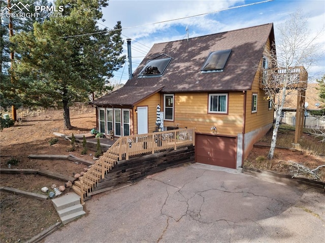 view of front of property featuring a garage and a wooden deck