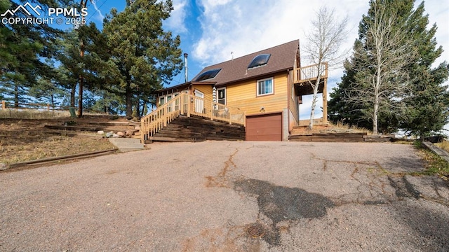 view of front of house with a garage and a deck