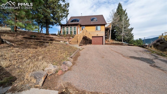 view of front of house with a mountain view and a garage