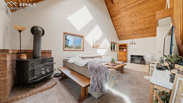 bedroom with wood ceiling, high vaulted ceiling, carpet, a fireplace, and a wood stove