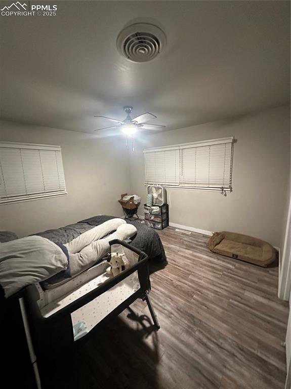 bedroom with hardwood / wood-style flooring and ceiling fan