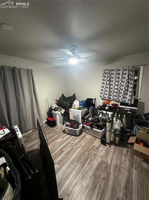 bedroom featuring hardwood / wood-style flooring and ceiling fan