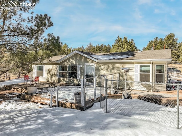 view of snow covered rear of property