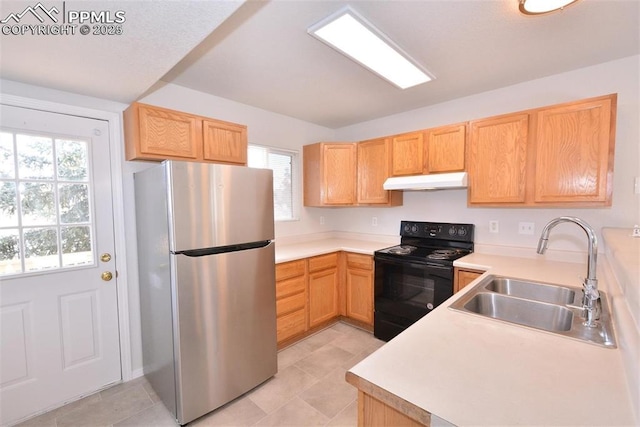 kitchen with stainless steel fridge, black electric range oven, sink, and light brown cabinets