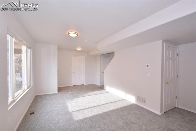 empty room featuring light colored carpet