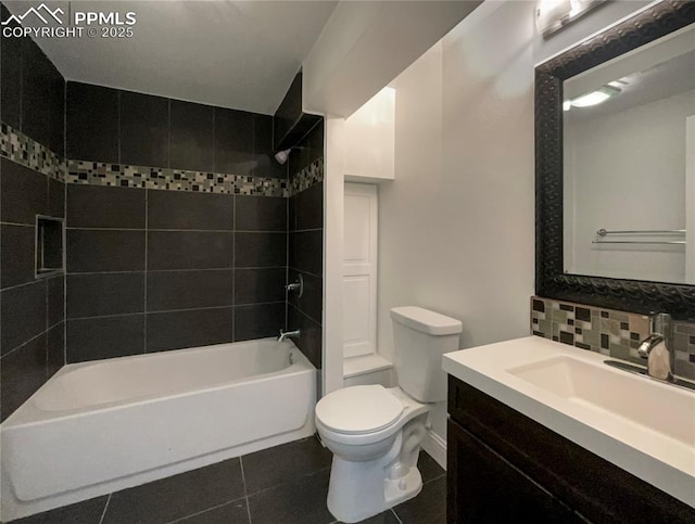 full bathroom featuring tasteful backsplash, vanity, tiled shower / bath, tile patterned floors, and toilet