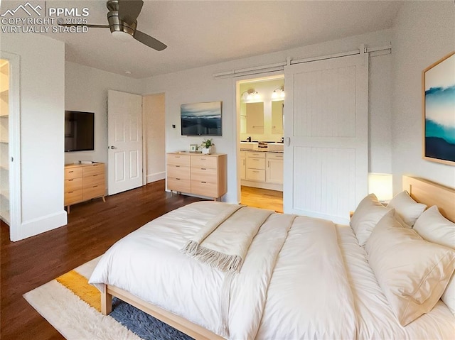 bedroom with ensuite bathroom, ceiling fan, and dark hardwood / wood-style flooring