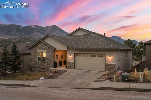 view of front of property featuring a garage and a mountain view