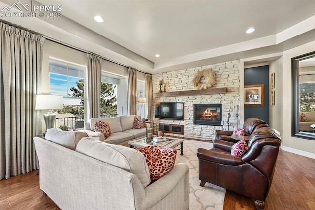 living room with hardwood / wood-style flooring and a fireplace