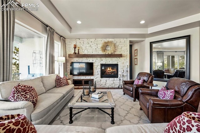 living room with a stone fireplace