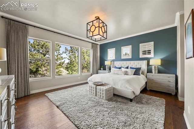 bedroom with ornamental molding and dark hardwood / wood-style floors