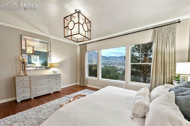 bedroom featuring dark hardwood / wood-style flooring, a notable chandelier, and crown molding