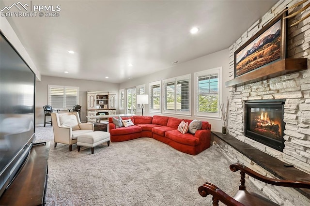 living room featuring a fireplace and carpet