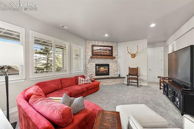 living room featuring a fireplace and carpet flooring