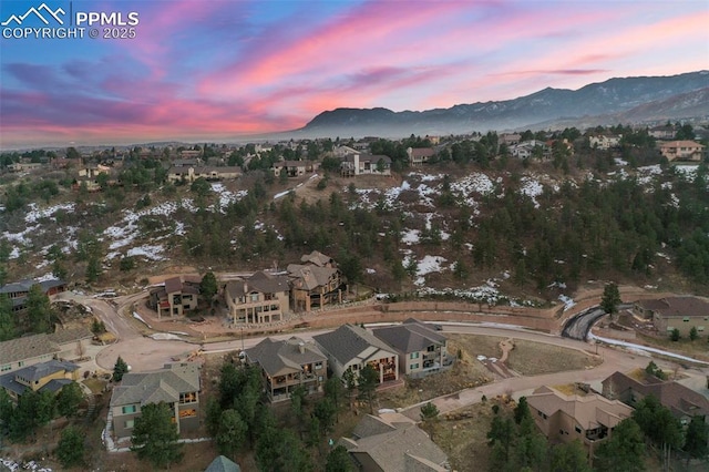 aerial view at dusk featuring a mountain view