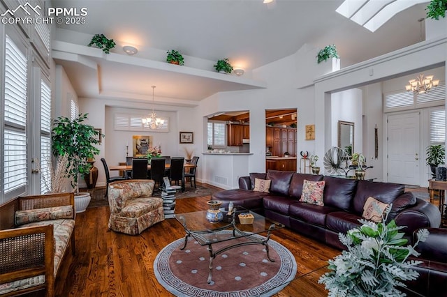 living room featuring a notable chandelier and dark wood-type flooring