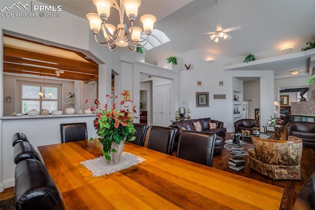 dining area with vaulted ceiling and ceiling fan with notable chandelier