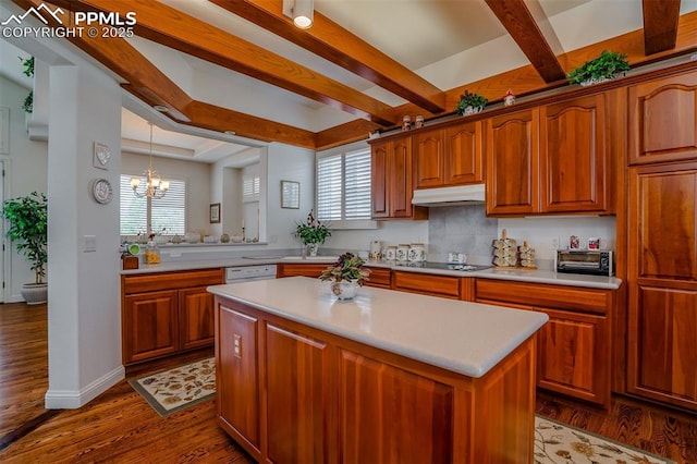 kitchen featuring black electric cooktop, a healthy amount of sunlight, a center island, and dark wood-type flooring