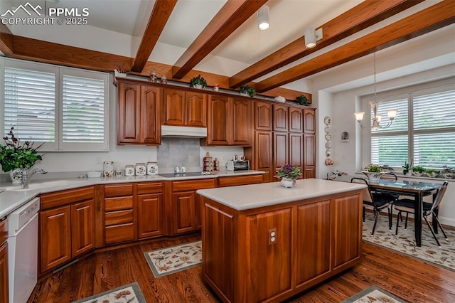 kitchen featuring dishwasher, hanging light fixtures, a kitchen island, black electric cooktop, and beamed ceiling